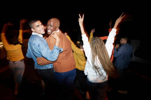 cheerful men dancing with friends at night - fashion stock pictures, royalty-free photos & images