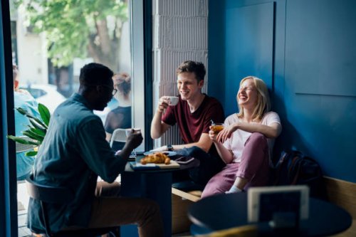 cheerful multi ethnic group of friends having a breakfast togetherâ in a cafe - coffee stock pictures, royalty-free photos & images