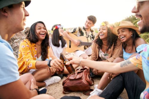 cheerful multiethnic group of friends gathering at the beach. - concert stock pictures, royalty-free photos & images