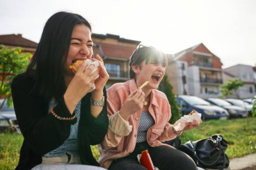 cheerful outdoor lunch - junk food stock pictures, royalty-free photos & images