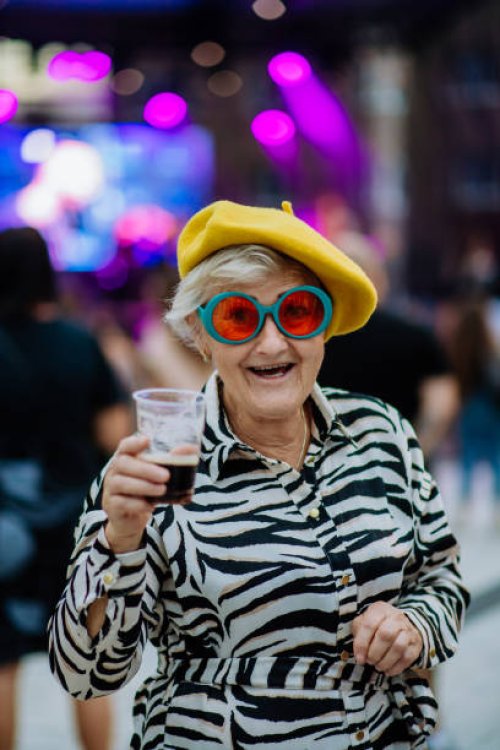 cheerful senior enjoying outdoor night concert in city. - concert stock pictures, royalty-free photos & images
