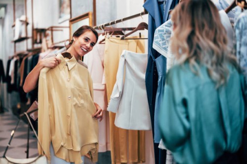 cheerful woman shopping for clothes in boutique store - fashion stock pictures, royalty-free photos & images