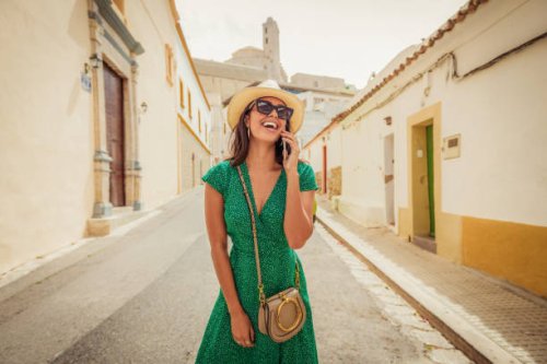 cheerful woman talking on her smartphone - travel stock pictures, royalty-free photos & images