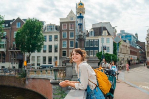cheerful woman walking in amsterdam in summer - travel stock pictures, royalty-free photos & images