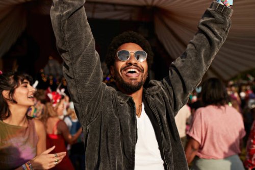 cheerful young man dancing with arms raised near girlfriend - concert stock pictures, royalty-free photos & images