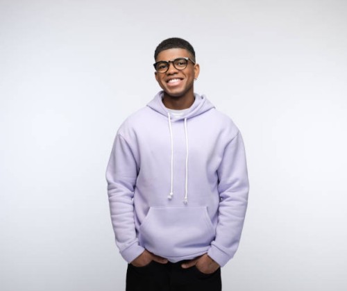 cheerful young man wearing lilac hoodie - fashion stock pictures, royalty-free photos & images