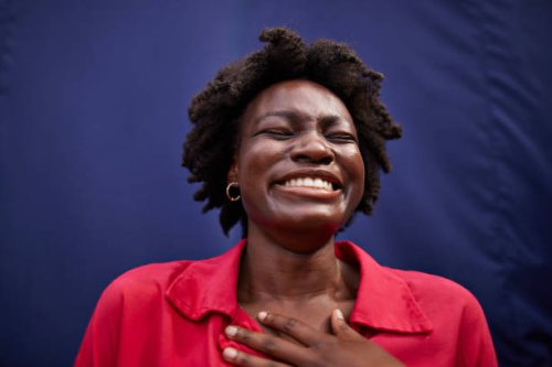 cheerful young woman smiling with eyes closed - hairstyle stockfoto's en -beelden