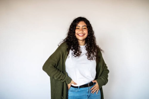 cheerful young woman standing on white background - fashion stock pictures, royalty-free photos & images