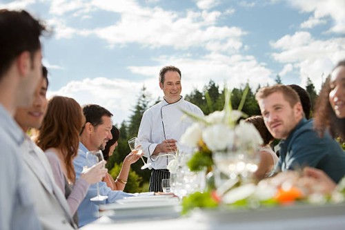 chef and people at outdoor dinner party - food stock pictures, royalty-free photos & images