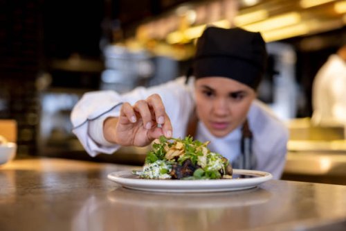 chef decorating a plate while working at a commercial kitchen - food stock pictures, royalty-free photos & images