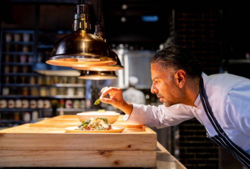 chef decorating a plate while working in the kitchen at a restaurant - food stock pictures, royalty-free photos & images