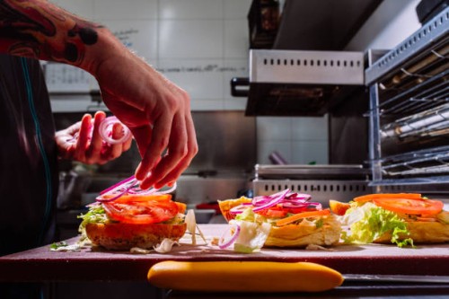chef preparing hamburgers in a restaurant - junk food stock pictures, royalty-free photos & images