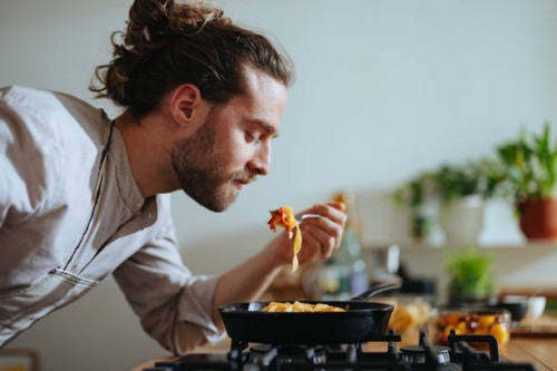 chef tasting pasta with fresh vegetables - food stock pictures, royalty-free photos & images