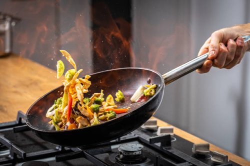 chef tossing flaming vegetable - food stock pictures, royalty-free photos & images