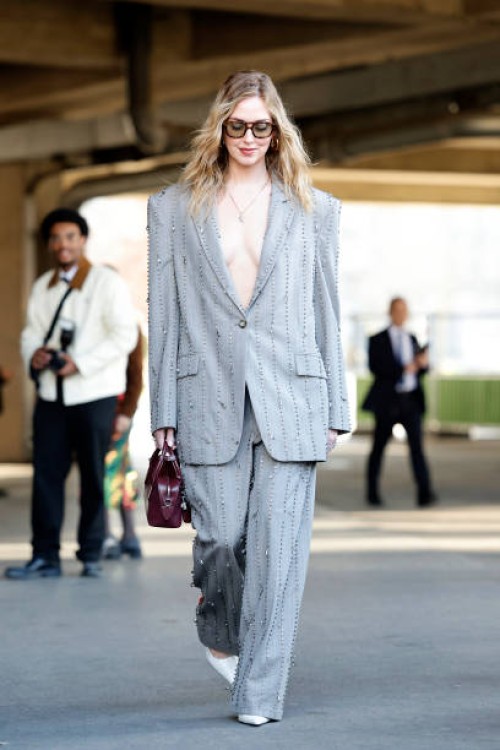 Chiara Ferragni wears crystals decorated grey suit, burgundy bag, white heels, outside Stella McCartney, during the Womenswear Fall/Winter 2025/2026...