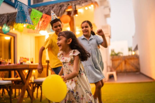child friends running and playing with balloons during party at house yard - garden decoration stock pictures, royalty-free photos & images