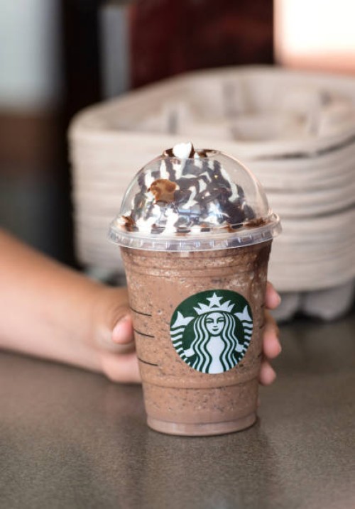 child hand holding a coffee frappuccino - junk food stock pictures, royalty-free photos & images
