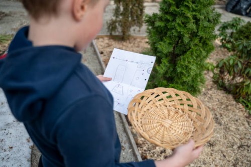 child standing in backyard, holding basket and map - garden decoration stock pictures, royalty-free photos & images