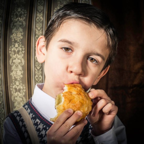 child who eat. vintage clothes - junk food stock-fotos und bilder