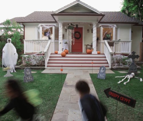 children (4-5) in halloween costume running at house - garden decoration stock pictures, royalty-free photos & images