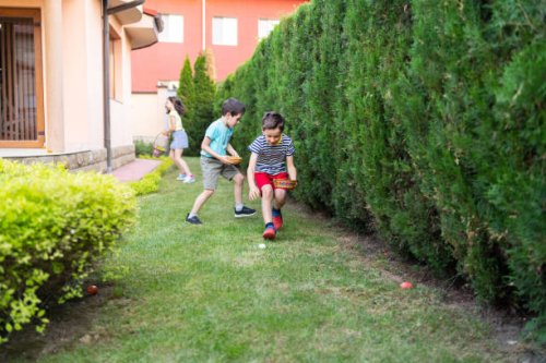 children easter egg hunting in a garden - garden decoration stock pictures, royalty-free photos & images