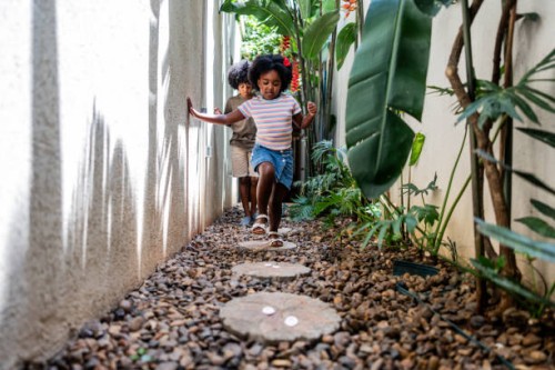 children hunting easter eggs at home - garden decoration stock pictures, royalty-free photos & images