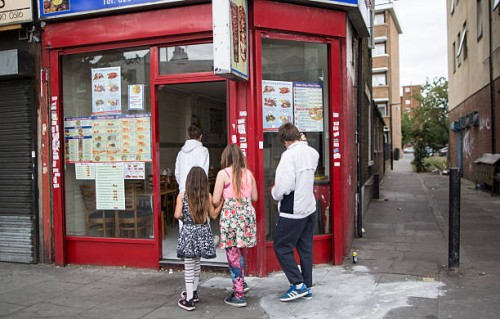 Children make their way into a fast food outlet in Tower Hamlets on August 10, 2015 in London, England.