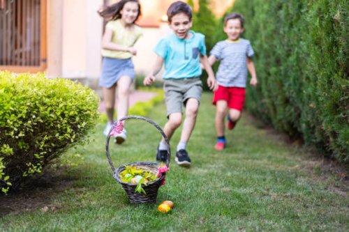 children running towards an easter basket on the ground - garden decoration stock pictures, royalty-free photos & images