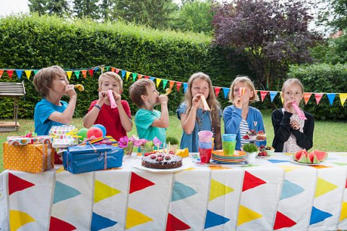 children using party blowers on a birthday party - garden decoration stock pictures, royalty-free photos & images