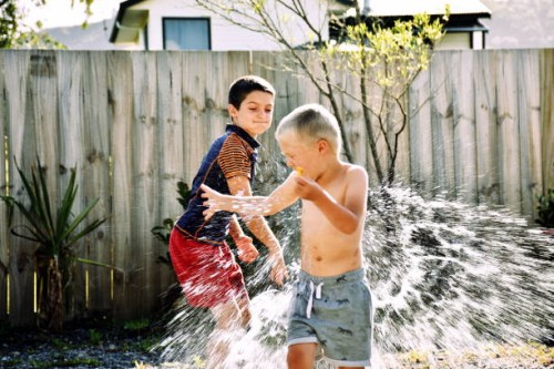 children water bomb fighting - garden decoration stock pictures, royalty-free photos & images