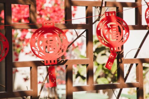 chinese new year paper craft decorations hanging outside on the front or back yard - garden decoration stock-fotos und bilder