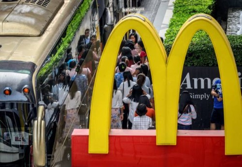 Chinese tourists board their bus in front of a McDonald's restaurant in Bangkok on January 30, 2020. Thailand has detected 14 cases so far of the...