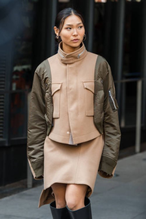 Chloe Kim wears beige and olive green jacket, beige mini skirt, outside Sacai, during the Haute Menswear Spring/Summer 2025 as part of Paris Fashion...