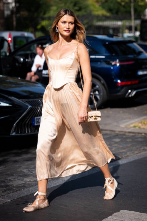 Chloe Lecareux wears a nude corset with matching maxi skirt, nude flat shoes and nude bag, outside Zimmermann, during the Womenswear Spring/Summer...