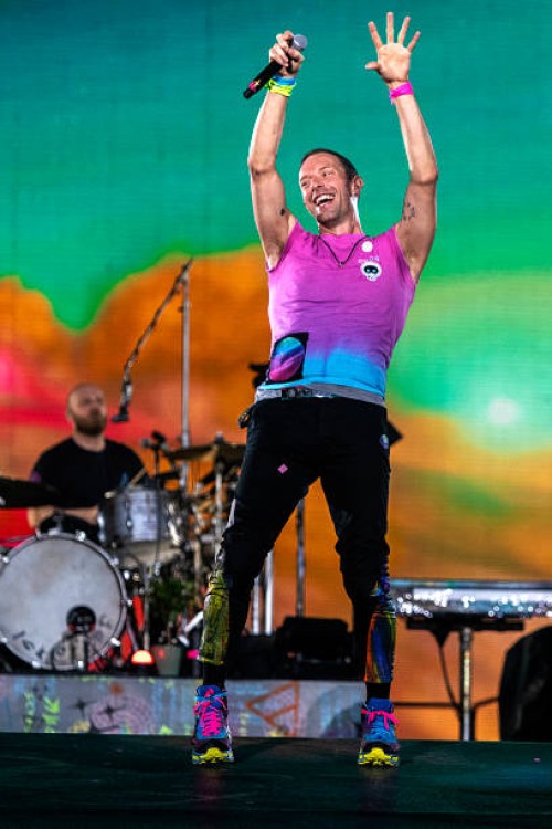Chris Martin and Will Champion of Coldplay perform live on stage at Parken Stadium on July 5, 2023 in Copenhagen, Denmark.