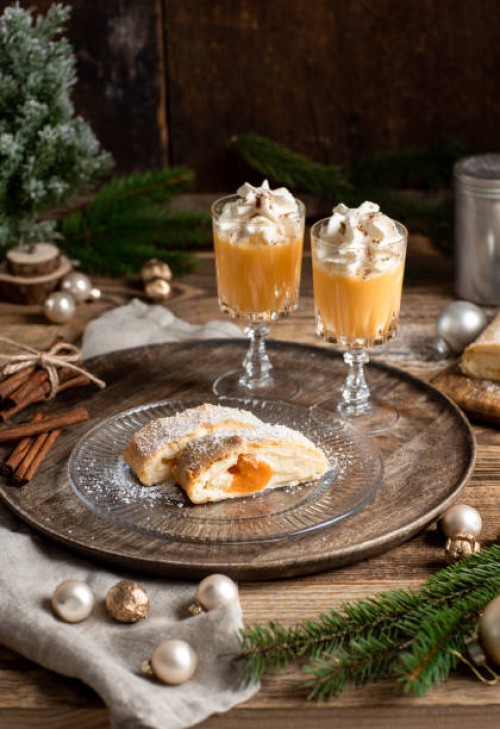 christmas dessert apricot strudel cake with advocaat eggnog and whipped cream in rustic wood kitchen - home decoration stock pictures, royalty-free photos & images