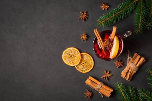 christmas flat lay background with cup of mulled red wine, fir tree, cinnamon, orange, spices and copy space - food stock pictures, royalty-free photos & images