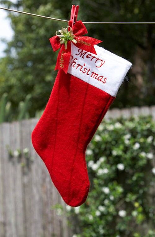 christmas stocking hanging on clothesline, outdoors - garden decoration stockfoto's en -beelden
