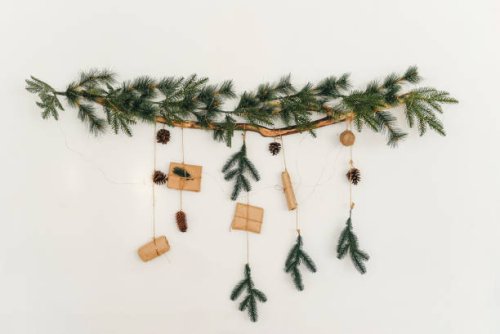 christmas tree branch with a garland and gifts on the wall. new year. christmas. christmas decor. christmas tree. christmas background. holiday. - home decoration stock pictures, royalty-free photos & images