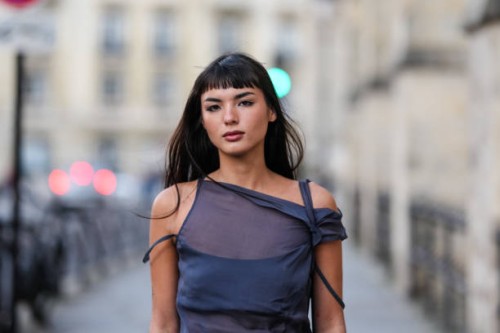 Clara Kong Vila wears short bangs long hair, dark navy blue sheer mesh sleeveless top, outside Paloma Wool, during the Paris Fashion week Women's...
