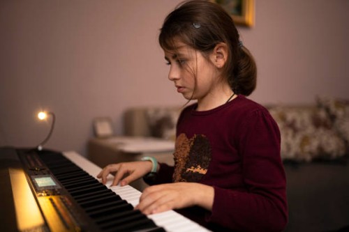 clever little girl learns the piano symphony. - concert stock pictures, royalty-free photos & images