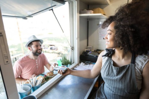 client using credit card for payment in food van - junk food stock pictures, royalty-free photos & images