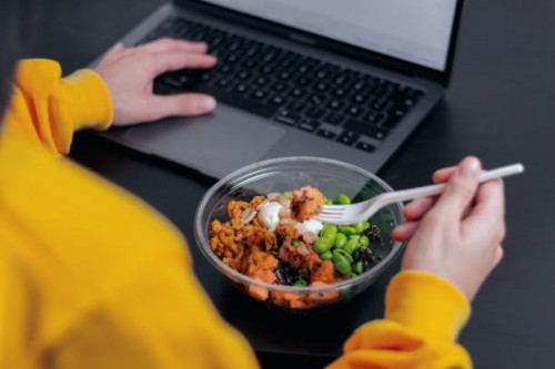 close-up of a person eating a healthy lunch in a plastic container. lunch at work. - junk food stock pictures, royalty-free photos & images