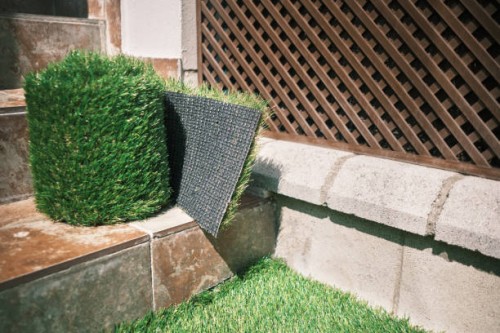 close-up of artificial grass carpet use as garden flouring or floor mat for office and home use - garden decoration stock pictures, royalty-free photos & images