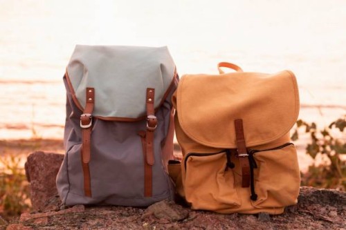 close-up of backpack on rock against sea - fashion stock pictures, royalty-free photos & images