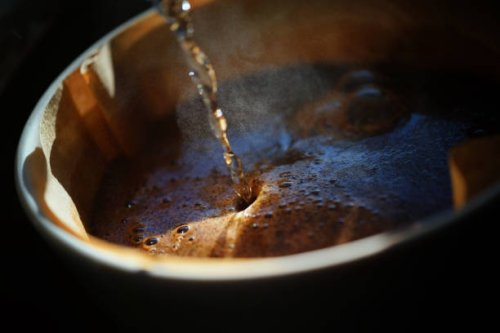 close-up of brewing coffee using a pour-over technique - coffee stock pictures, royalty-free photos & images