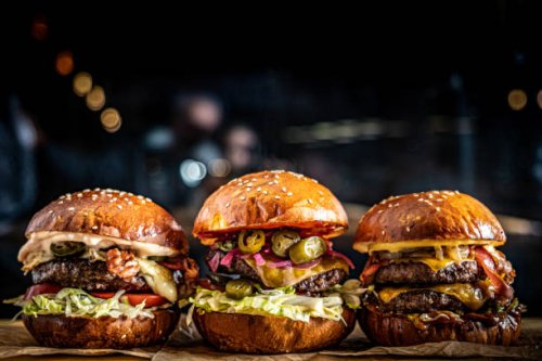close-up of burgers on table - junk food stock pictures, royalty-free photos & images