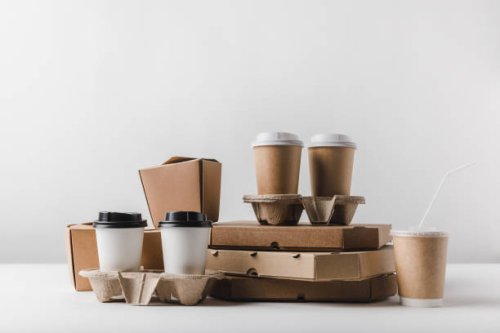 close-up of cardboard boxes on table against white background,romania - junk food stock pictures, royalty-free photos & images