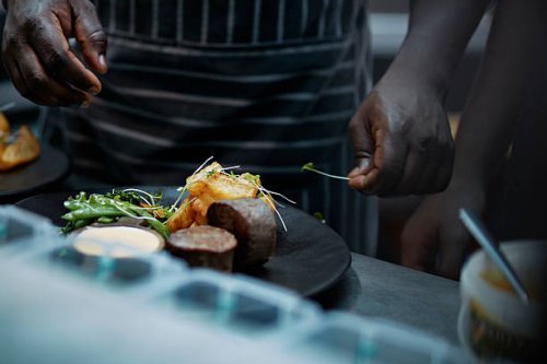 close-up of chef finishing dish in kitchen - food stock pictures, royalty-free photos & images