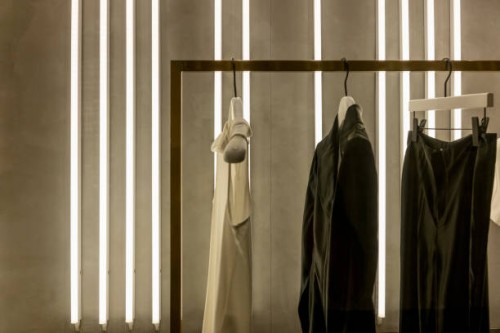 close-up of clothes hanging on window at store - fashion stock pictures, royalty-free photos & images